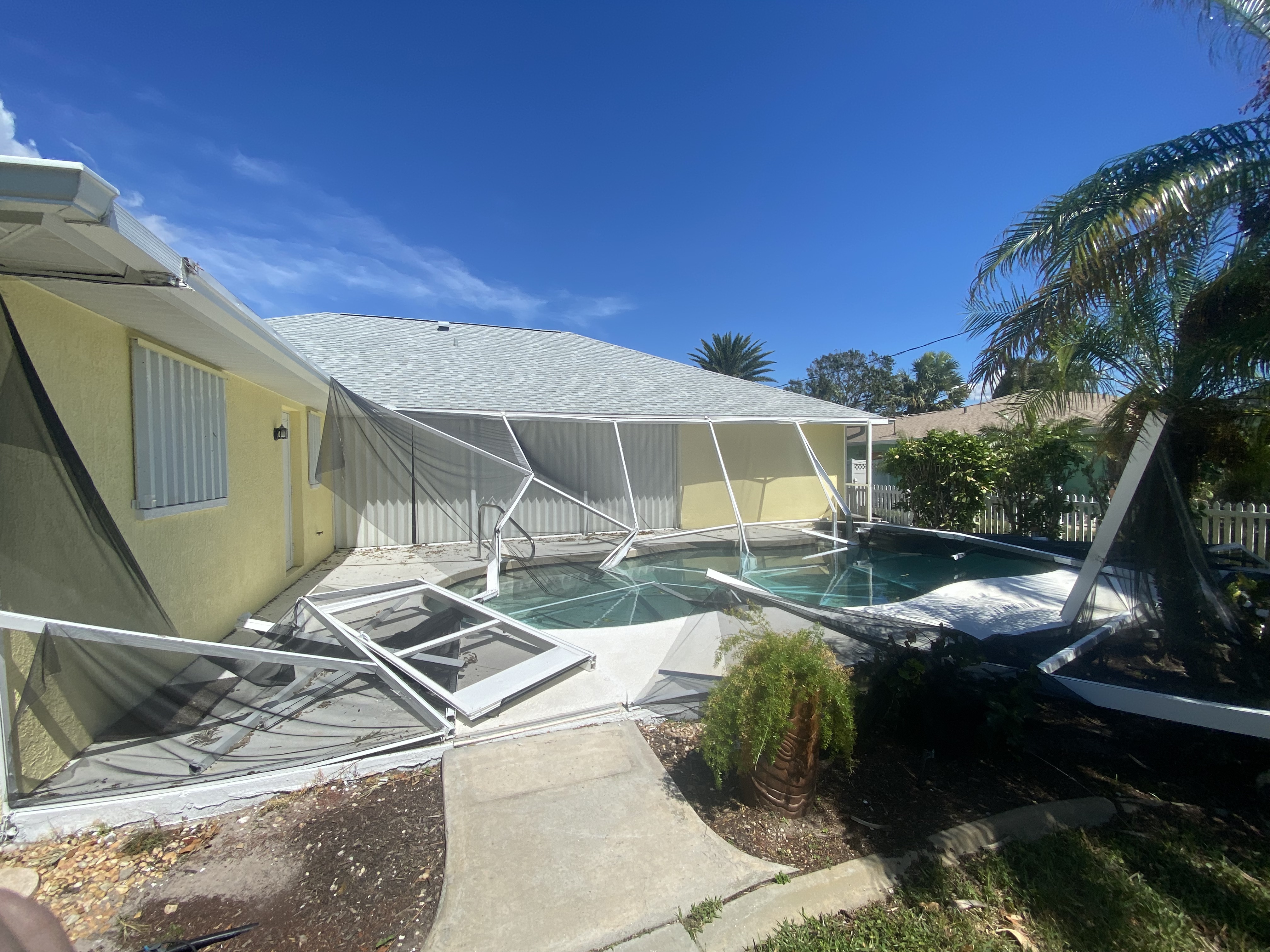 Before — collapsed pool enclosure